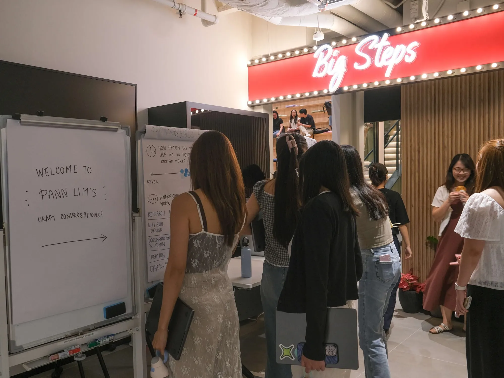 Attendees gather at the whiteboards near the Big Steps entrance before the talk.