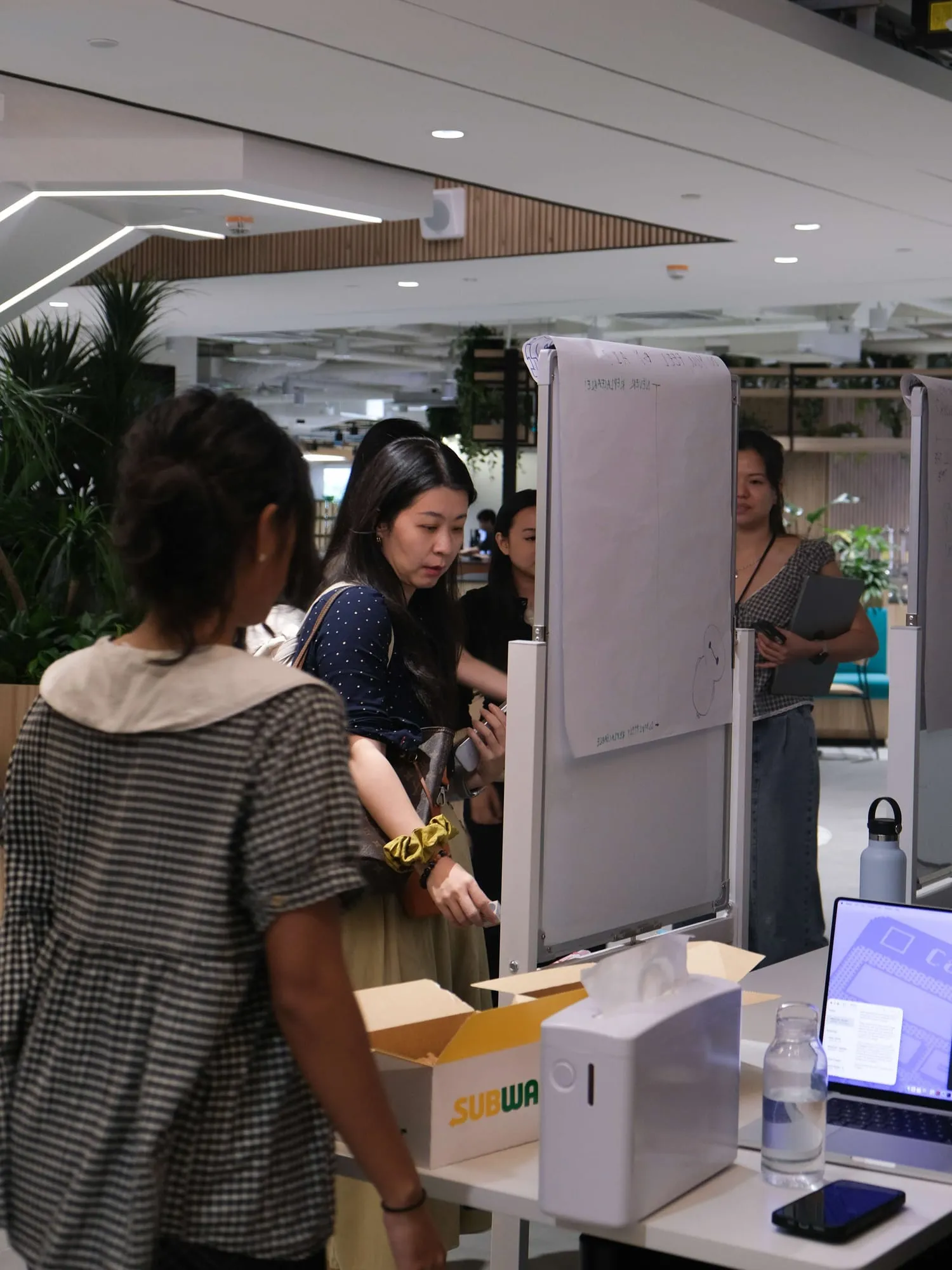 Attendees look at the survey boards at the registration table.