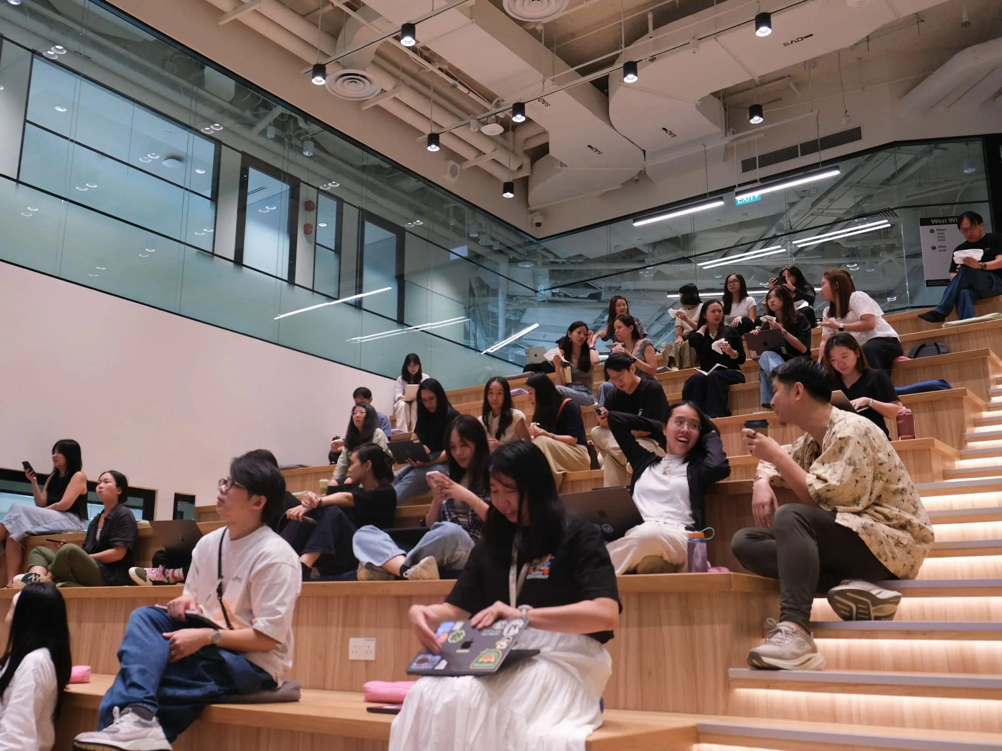 The audience settles into the tiered seating before the talk.