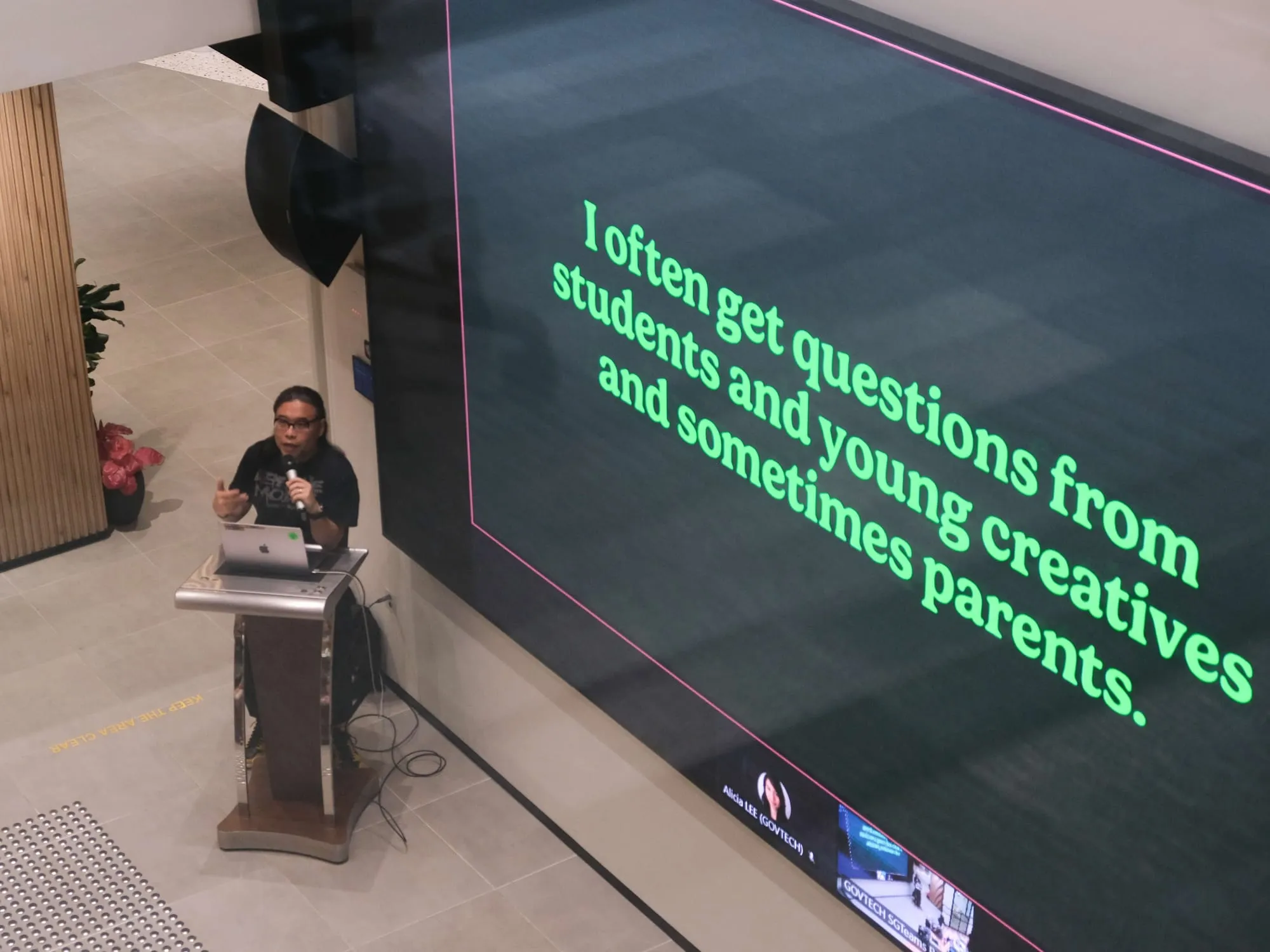 Pann speaks beside a slide reading: I often get questions from students and young creatives and sometimes parents.