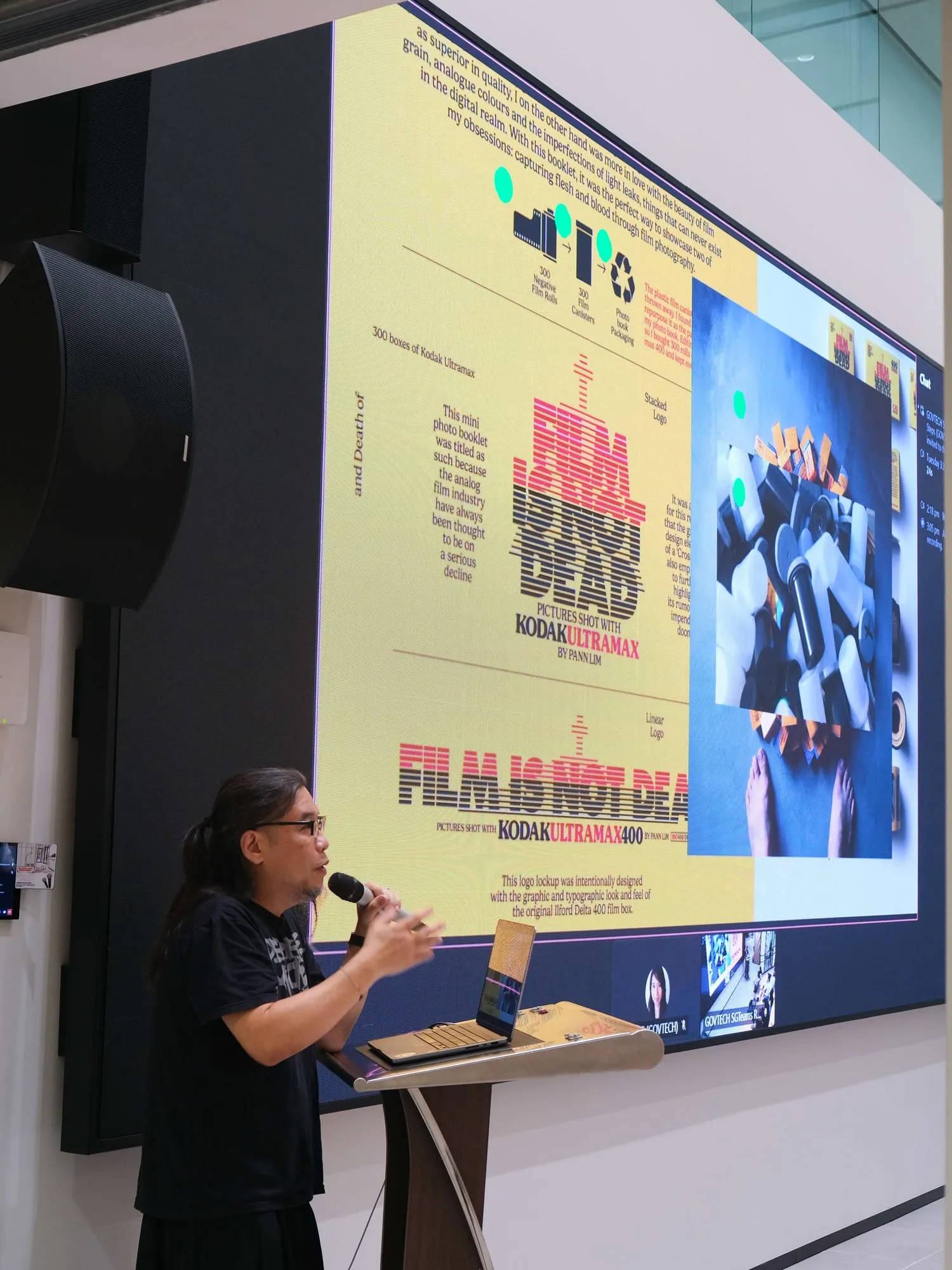 Pann speaks in front of a slide of Kinetic's poster work.