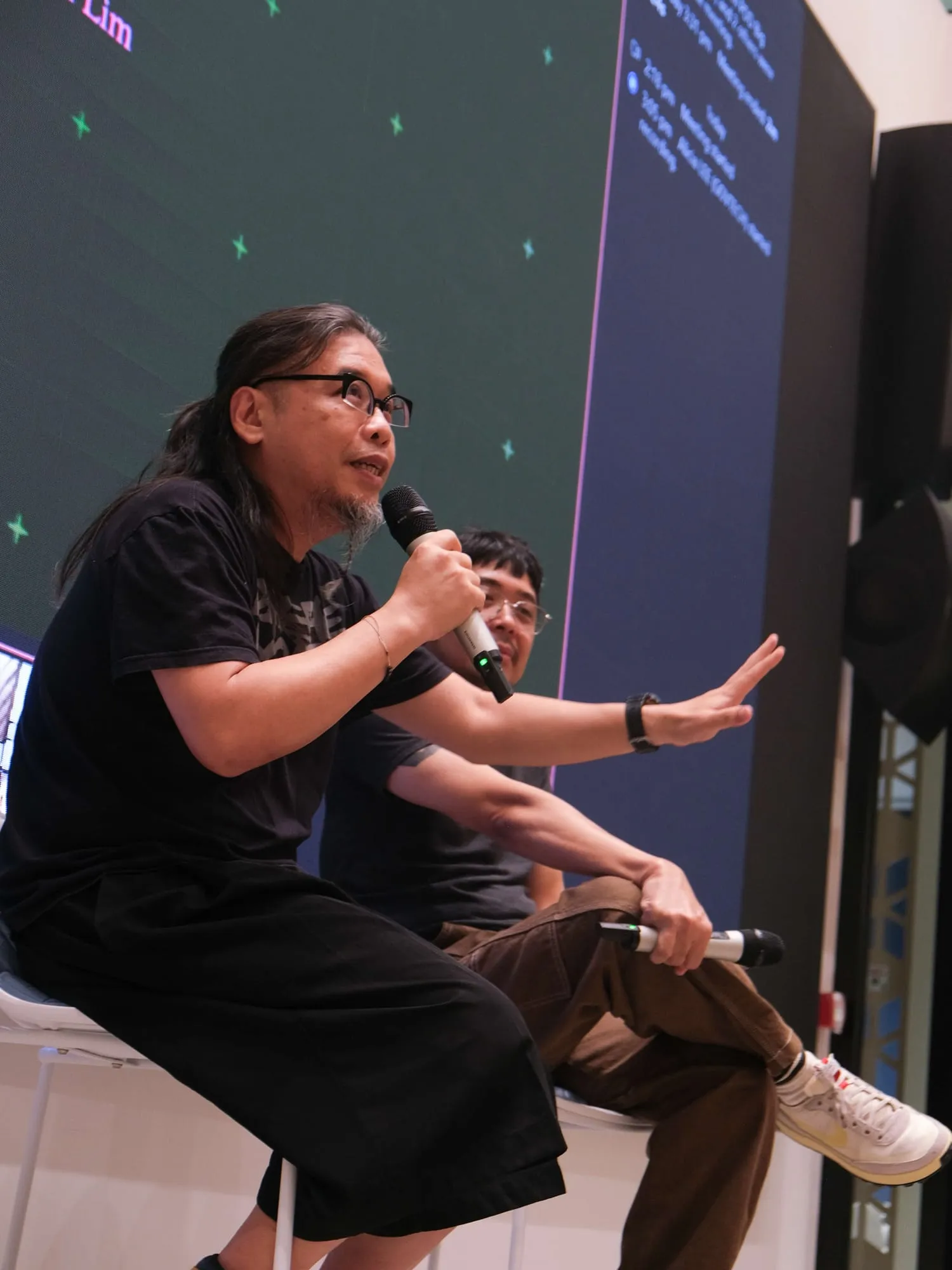 Pann gestures as he answers a question.